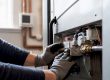 Technician inspecting furnace gas valve