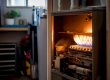 Furnace burner flame igniting amid dust particles