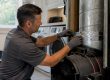 Technician sealing air duct during leakage test