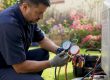 Technician recharging home AC with gauges