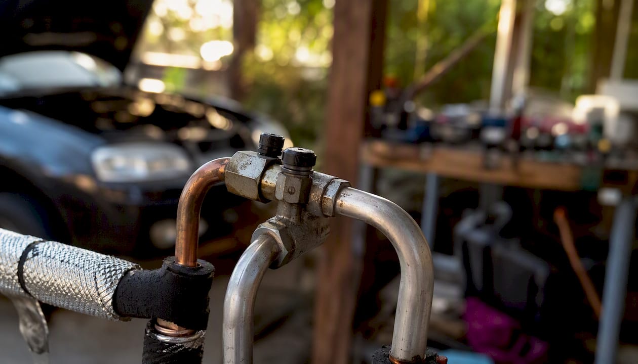 Close-up of car AC refrigerant line connection