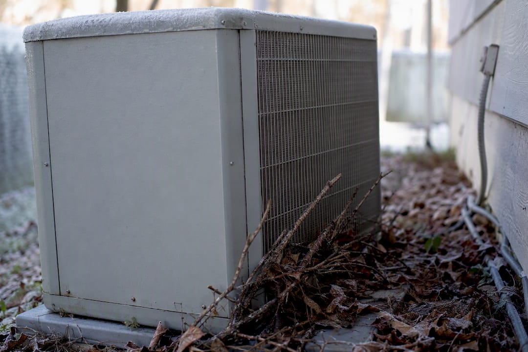 Heat pump coil blocked by leaves and snow buildup