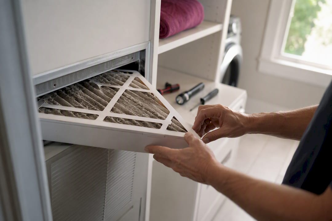 Close-up of hands replacing HVAC air filter