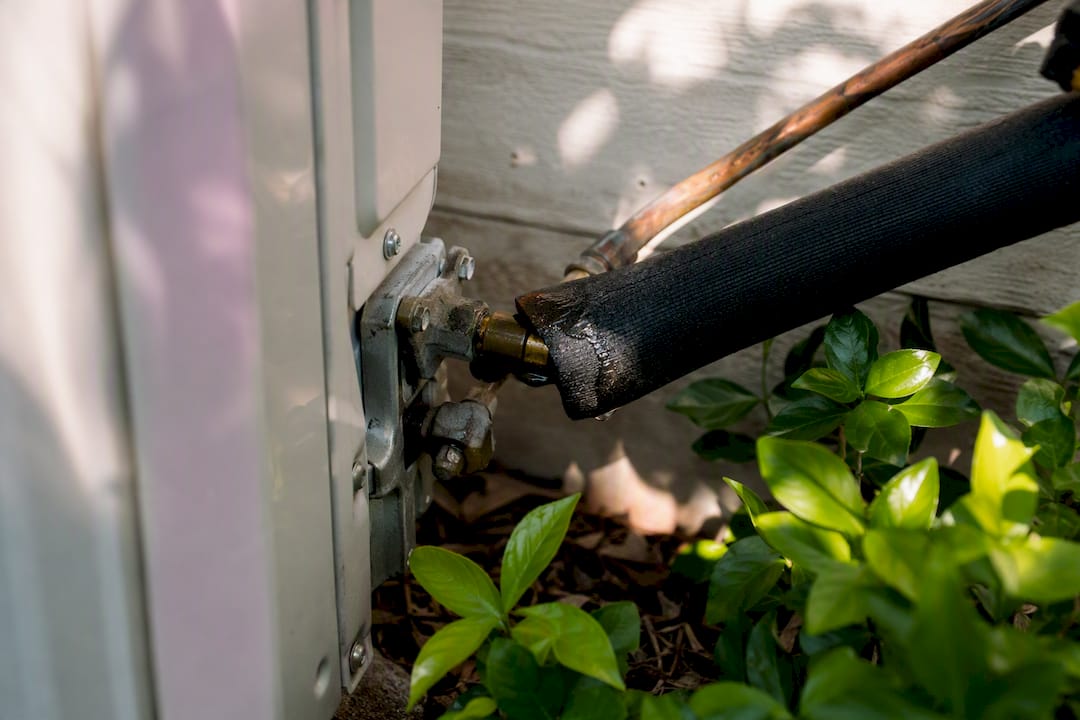 AC refrigerant line with oily leak residue