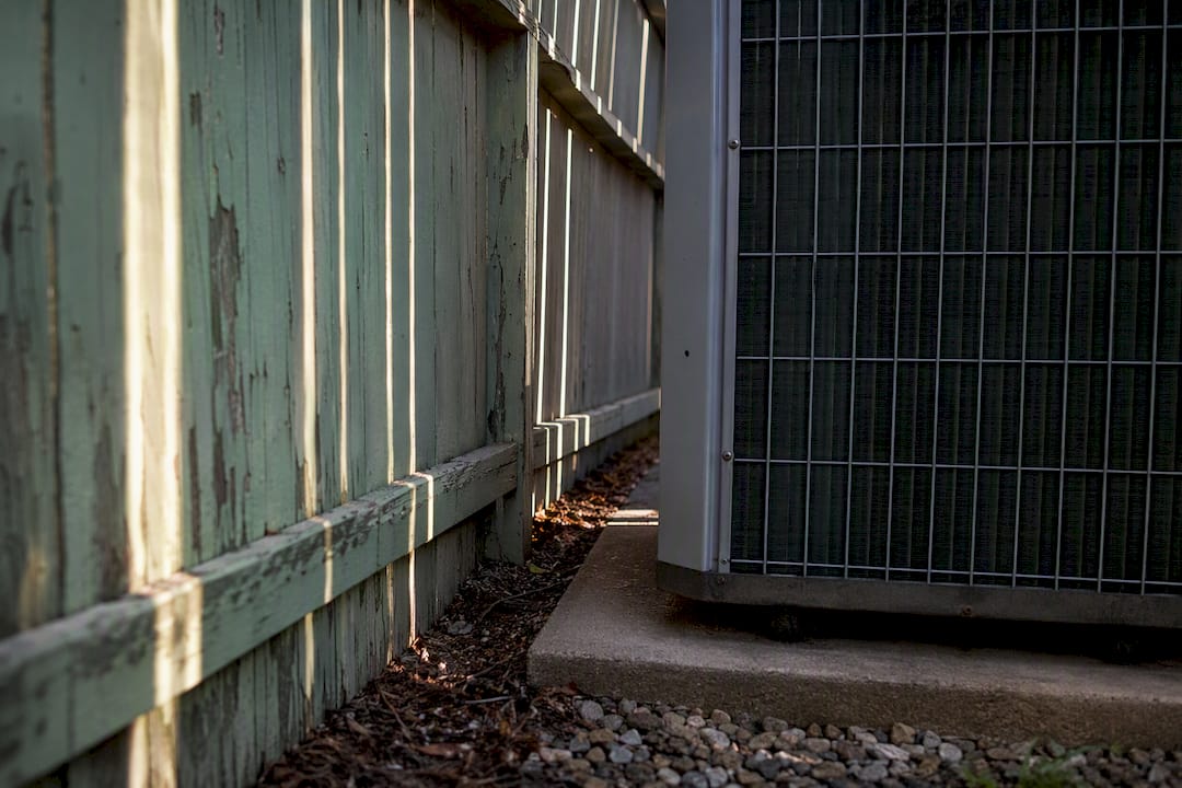 Privacy fence blocking AC condenser airflow