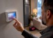 Homeowner checking a heat pump thermostat