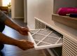 Homeowner replacing an HVAC air filter