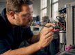 Technician diagnosing HVAC equipment in training