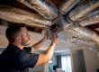 Technician adjusting HVAC zoning damper