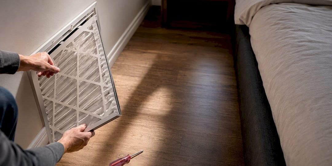 1789023738621_Homeowner-checking-a-return-air-filter Homeowner checking a return air filter