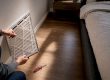 Homeowner checking a return air filter