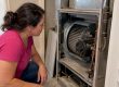 Homeowner visually checks furnace blower motor