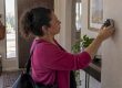Homeowner adjusting a smart thermostat before leaving